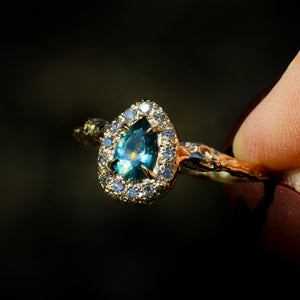 Valkyrie: 14K teal sapphire and grey diamond halo ring